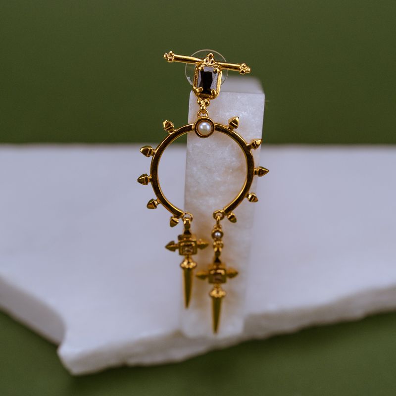 Stone Holds a Spiked Hoop Earring